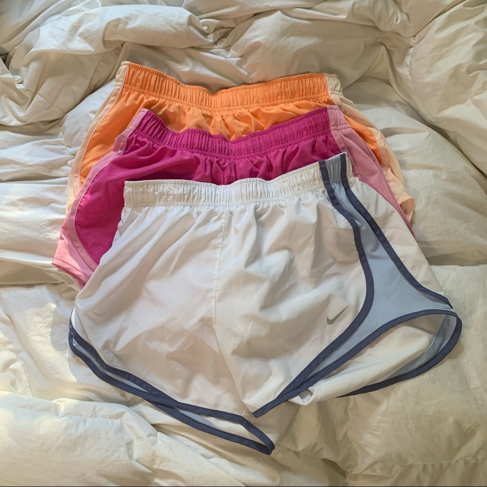 3 pairs of Nike dry-fit shorts, various colors.